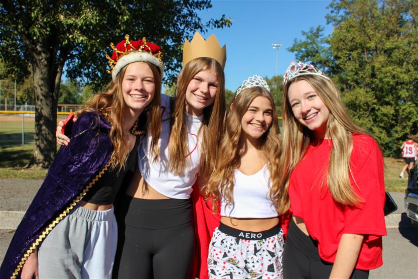Four students smile